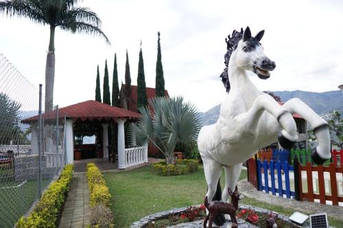 a statue of a horse standing next to a fence at Chalet El Pinal - Copacabana in Copacabana