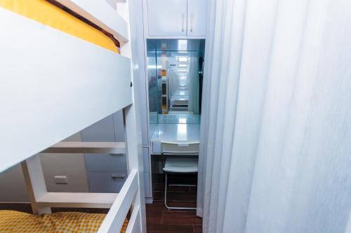 a small bathroom with a sink and a mirror at Beauty Cindrella Home Makati Penthouse 3 Bedroom in Manila