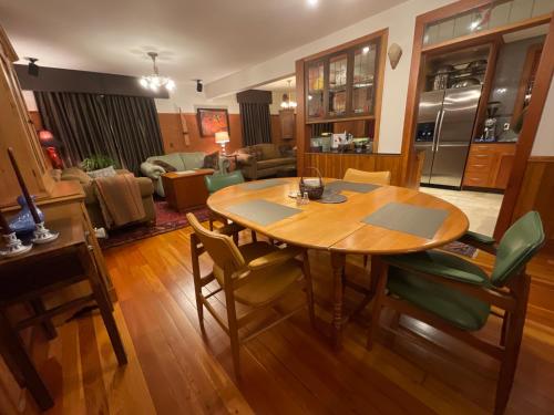 a kitchen and living room with a wooden table and chairs at Blackbird Glen Bed and Breakfast, Glenmore, Kelowna, BC in Kelowna