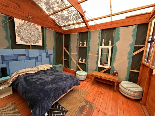 a bedroom with a bed and a toilet in it at Eko Aldea Kolybry in San Joaquín