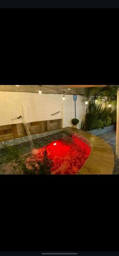 a fountain with red water in the middle of a room at La Quinta De Conin in Miranda