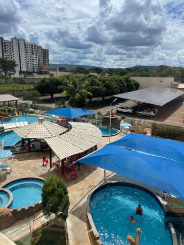 an overhead view of a pool with blue umbrellas at Condomínio Thermas Place in Caldas Novas
