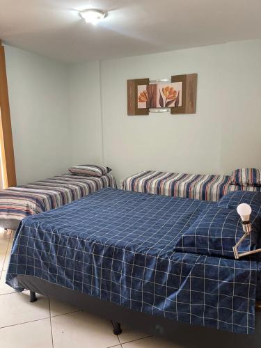 two beds sitting next to each other in a room at Condomínio Thermas Place in Caldas Novas