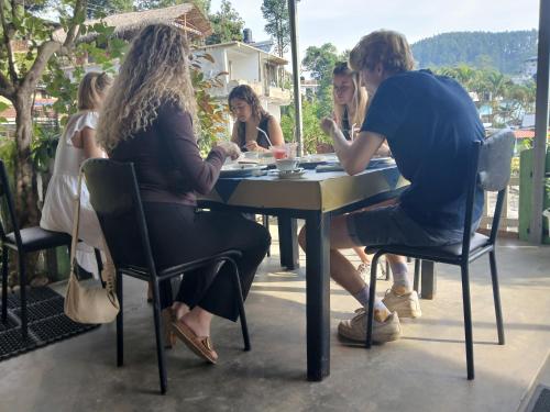 a group of people sitting at a table at Green Peak - Mountain View Hotel & Restaurant in Ella
