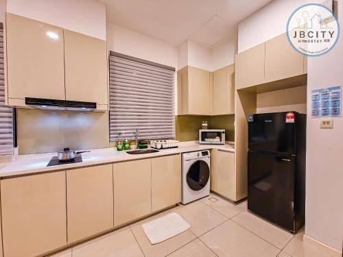 a kitchen with a black refrigerator and a dishwasher at Skudai Paradigm Mall by RR JBcity in Johor Bahru