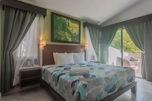 a bedroom with a bed and a balcony with a view at Villa Beach Adventure Relax Holiday Private Pool BBQ Maid Service Golf in Playa del Carmen