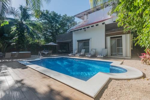 a swimming pool in the backyard of a house at Villa Beach Adventure Relax Holiday Private Pool BBQ Maid Service Golf in Playa del Carmen
