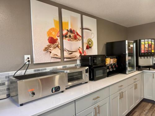 a kitchen with a counter with a microwave and a microwave at Baymont by Wyndham Great Falls City Center in Great Falls
