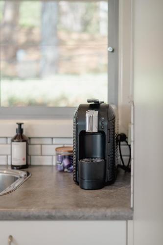 a coffee maker sitting on a counter in a kitchen at Kidman at Boardwalk Villas in Metung