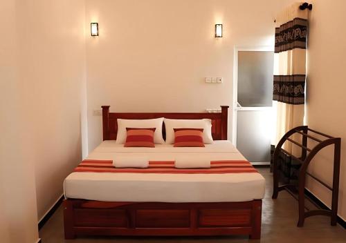 a bedroom with a large bed with two pillows at Blue Sky in Mirissa