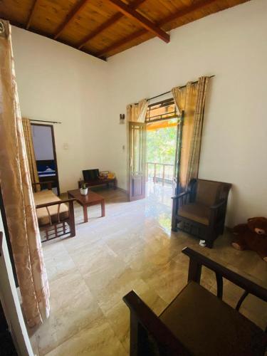 a living room with a couch and a table at Fine Homes in Kalutara