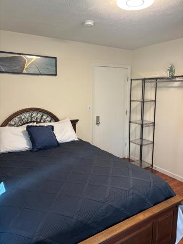 a bedroom with a large bed with a blue comforter at Atlanta Charming Private Room 1 in Atlanta