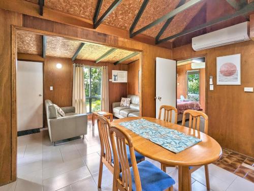 a dining room with a table and chairs at Gumnut Glen Cabins in Yeppoon