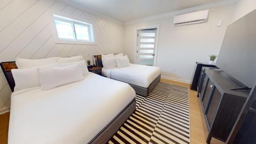 a hotel room with two beds and a television at The Surf Club in Ocean City