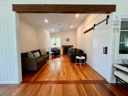 a living room with a couch and a table at Alexander's Cottage, Pebbly Beach in East Lynne
