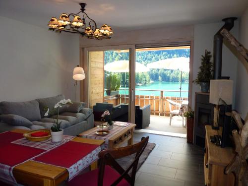 a living room with a couch and a table at Hotel Mont.Lac in Champex