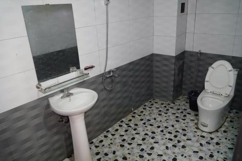 a bathroom with a sink and a toilet at Homestaychivieng in Yên Minh