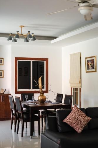 a dining room with a table and chairs at Princess Massarossa Pool Villa Pattaya-24 in Pattaya