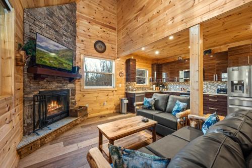 a living room with a fireplace in a log cabin at Big Bear Bend Gatlinburg Chalet Village in Gatlinburg