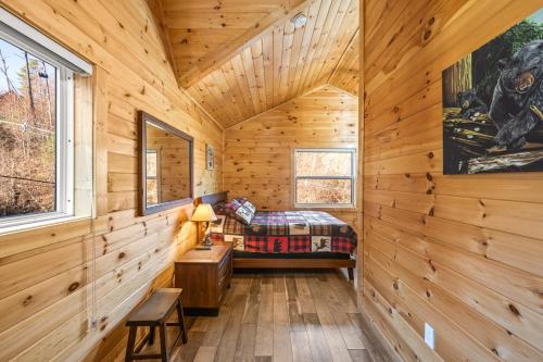 a log cabin bedroom with a bed and a desk at Big Bear Bend Gatlinburg Chalet Village in Gatlinburg