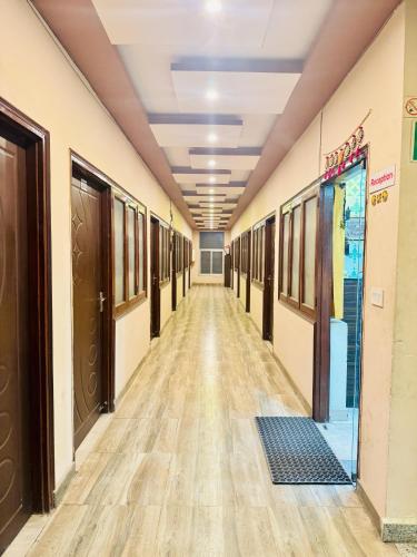 an empty hallway in a building with wood floors at Hotel Airport Gateway in Lucknow