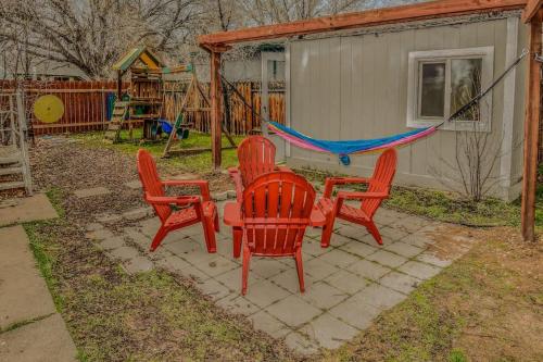 a group of red chairs and a hammock in a backyard at Reno Retreat 3 King Beds by Casinos and University in Reno