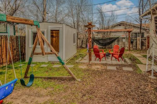 a playground with red chairs and a swing at Reno Retreat 3 King Beds by Casinos and University in Reno