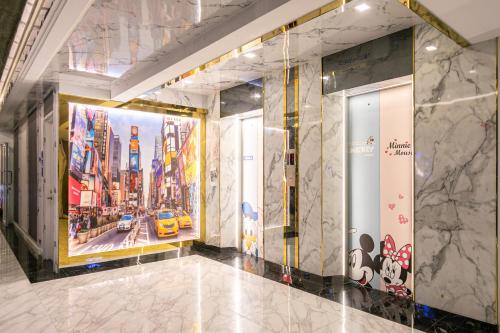 a hallway with a mural of a city at Airbus Hotel At Phawana Station in Bangkok
