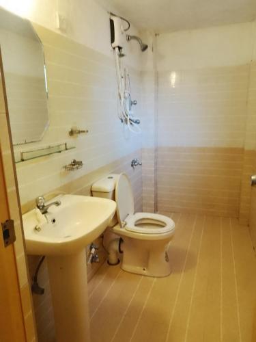 a bathroom with a toilet and a sink at Banana Leaf Garden in Weligama
