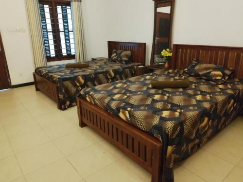 three beds sitting in a room with at Banana Leaf Garden in Weligama