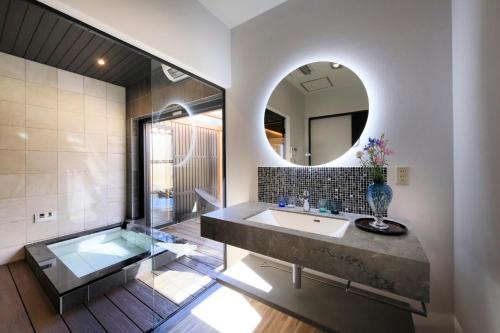 a bathroom with a large sink and a mirror at Otogitei Kofu in Achi