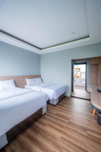 Ένα ή περισσότερα κρεβάτια σε δωμάτιο στο Elge Hotel and Villa Sarangan
