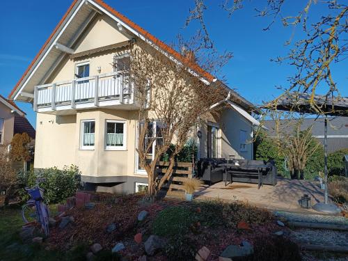 a large white house with a porch and a yard at Ferienhaus an der Ronneburg in Ronneburg