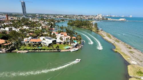 an aerial view of a river with a boat at Lujoso Penthouse con alberca vista increíble al Mar y Rio en el Estero in Boca del Río