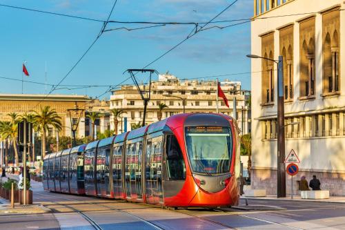 a red tram on a city street with buildings at Hyatt Residence Casa Voyageur in Casablanca