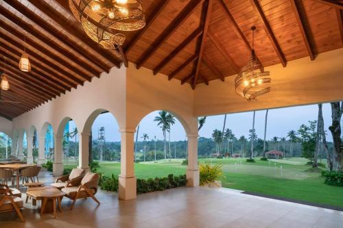 a large living room with a view of a golf course at Canterbury Golf Resort Apartment in Gonapola