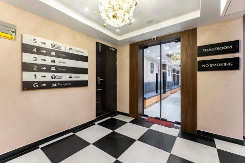 a lobby with a checkered floor and a no smoking sign at Medalio Boutique Gangtok with Mountain View in Gangtok