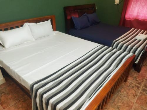 two beds sitting next to each other in a room at Private Villa With Swimming Pool at White Town in Puducherry