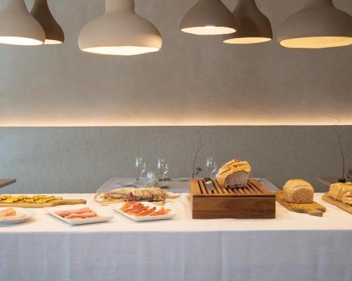 a table with several plates of food on it at Les Clarisses Boutique Hotel in Vic