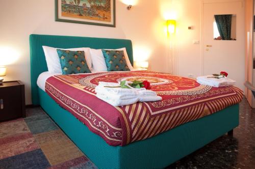 a bedroom with a bed with towels on it at Arena d'Intorno in Verona