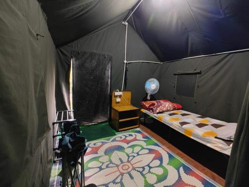 a bedroom with a bed in a tent at Nisarg Camping Pods in Almora