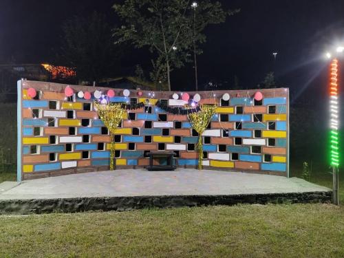 a wall with a table in front of it at Nisarg Camping Pods in Almora
