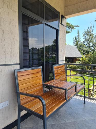 a wooden bench sitting on the porch of a house at Materuni Homes in Moshi