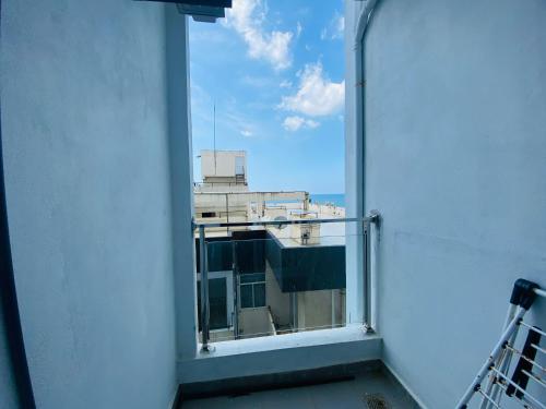 an open window with a view of a building at Blue Star Apartments three bedroom apartment in Dehiwala