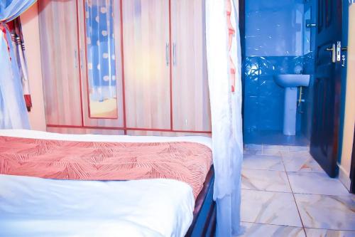 a room with two beds and a bathroom at 5 bedroom bungalow in Kisumu City in Kisumu