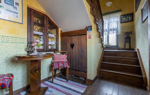 a hallway with a wooden door and stairs in a house at 2 Bedroom Amazing Home In Draz in Draž