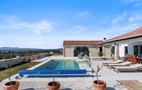 a swimming pool in the backyard of a house at Lovely Home In Krkovic in Prović