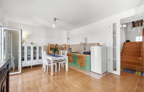 a kitchen with a table and a white refrigerator at Lovely Home In Krkovic in Prović