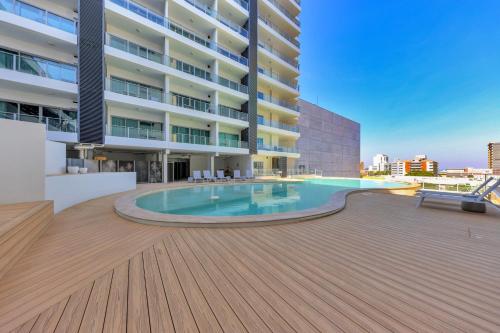 a swimming pool in the middle of a building at Pandanas Studio Darwin CBD Water Views in Darwin
