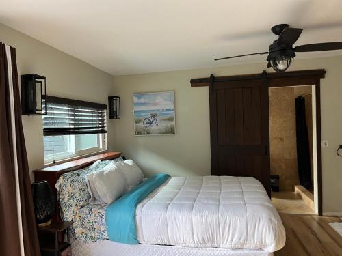 a bedroom with a bed and a ceiling fan at Leucadia Coastal House in Encinitas
